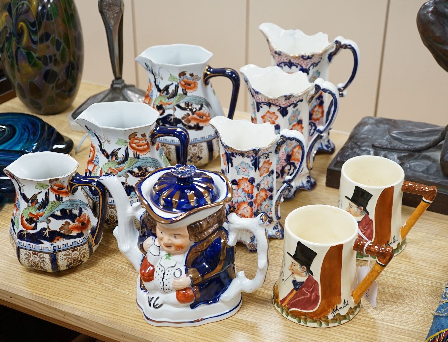 Two sets of Victorian graduated jugs, a Toby tea pot and two John Peel musical mugs